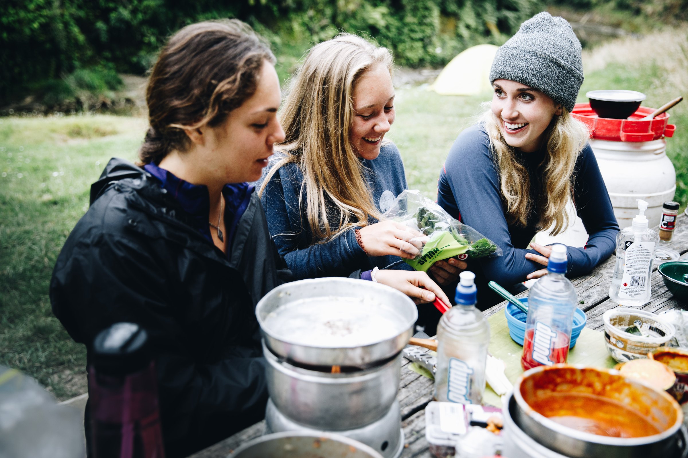 Students cooking and making food while camping